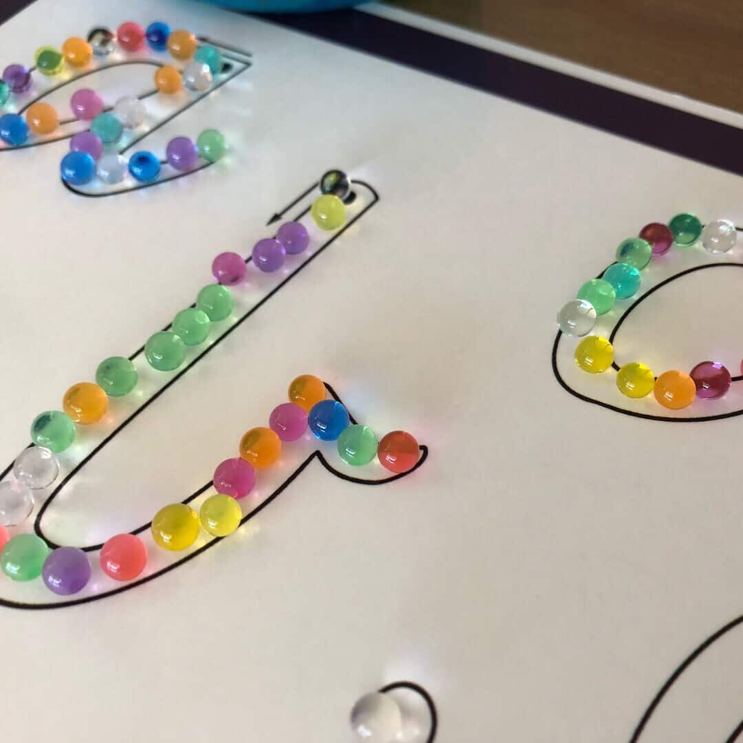 water beads on alphabet mat