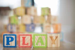 wooden blocks spelling the word play