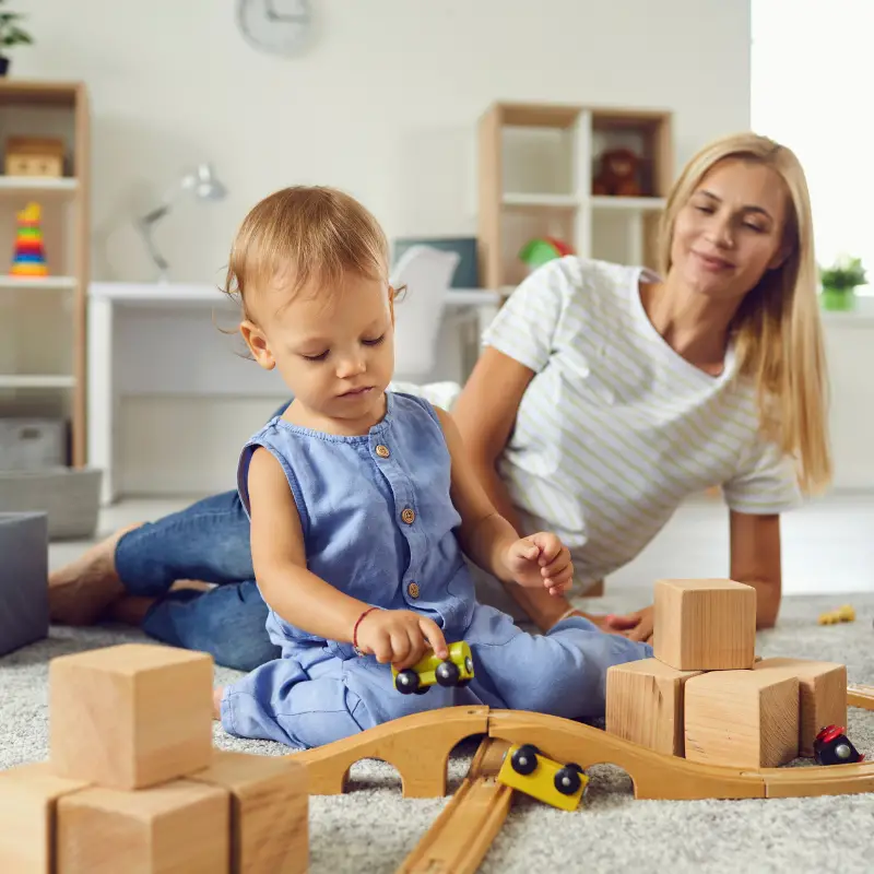 boy playing with wooden toys