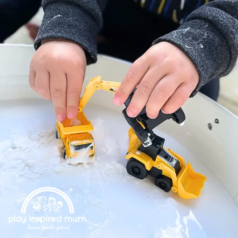 Messy play oobleck construction trucks.