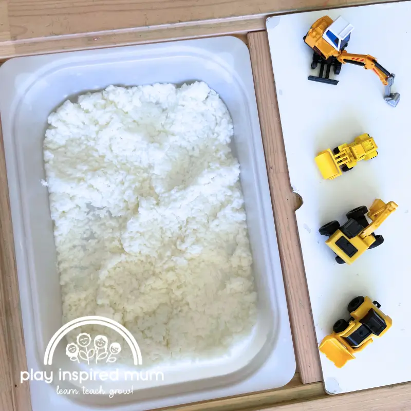 paper pulp sensory bin with construction vehicles