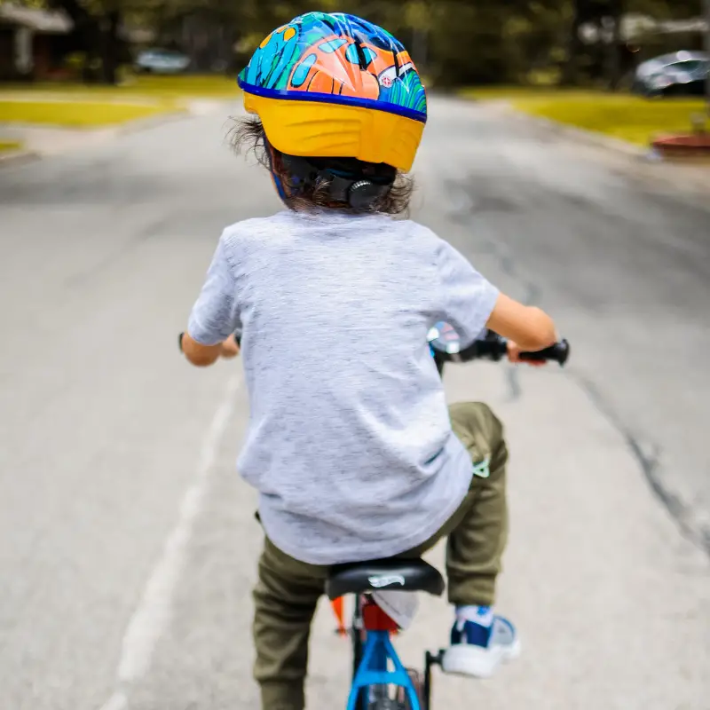 Child riding bike with helmet