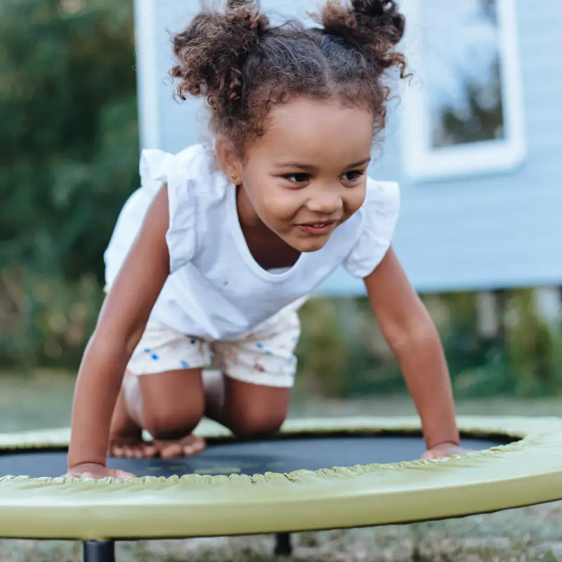 Girl playing on trampoline