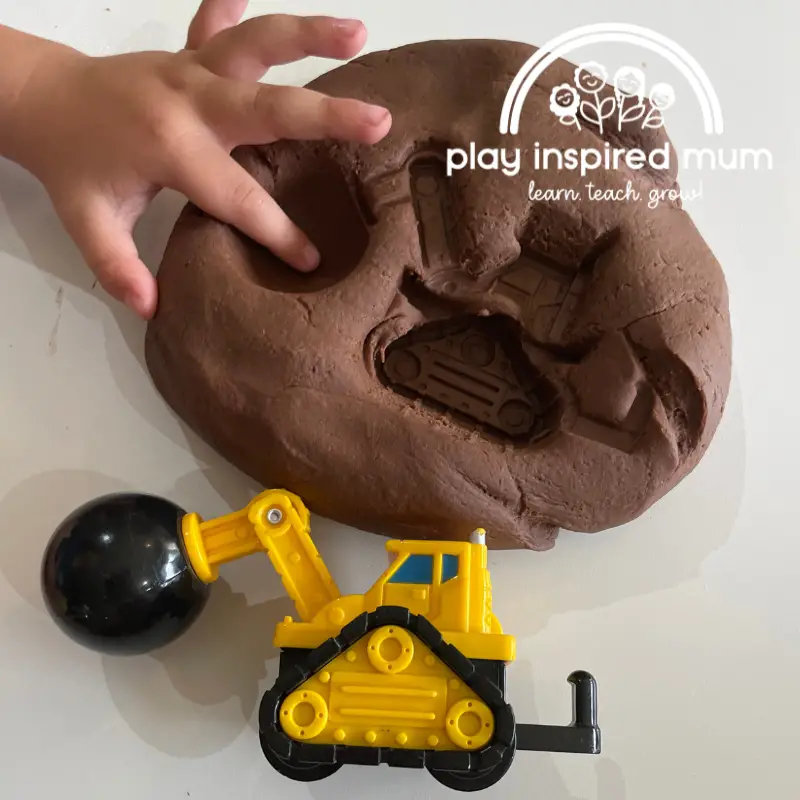 construction truck imprint in chocolate play dough