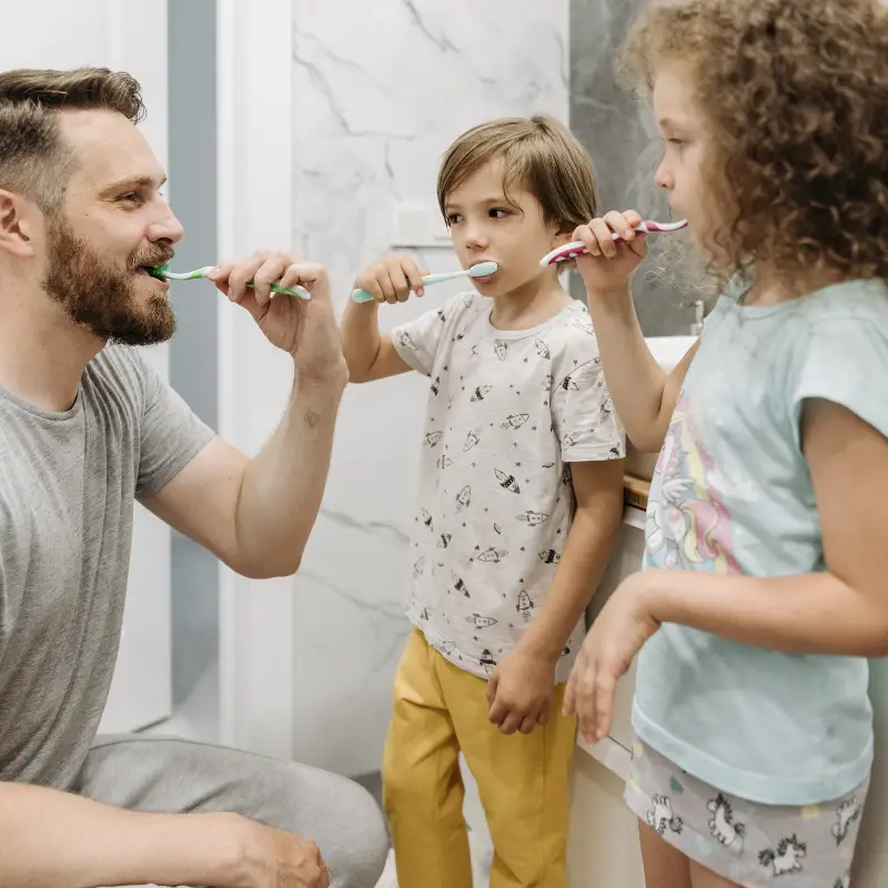 Family brushing teeth together